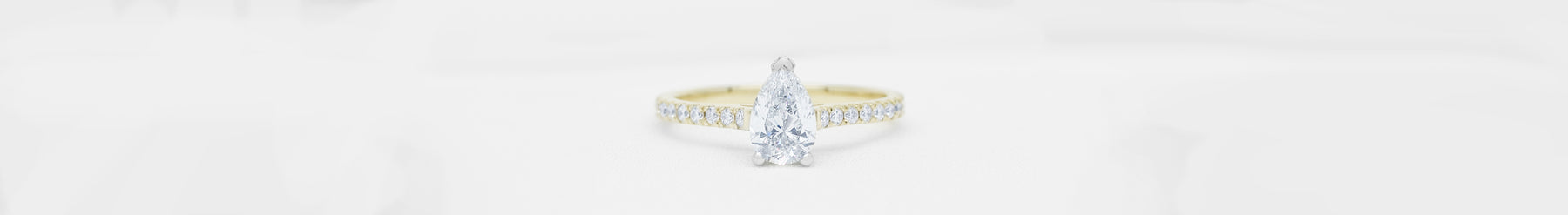Pear Cut Diamond Engagement Ring with Diamond Set Band in Yellow Gold and Platinum by The Village Goldsmith