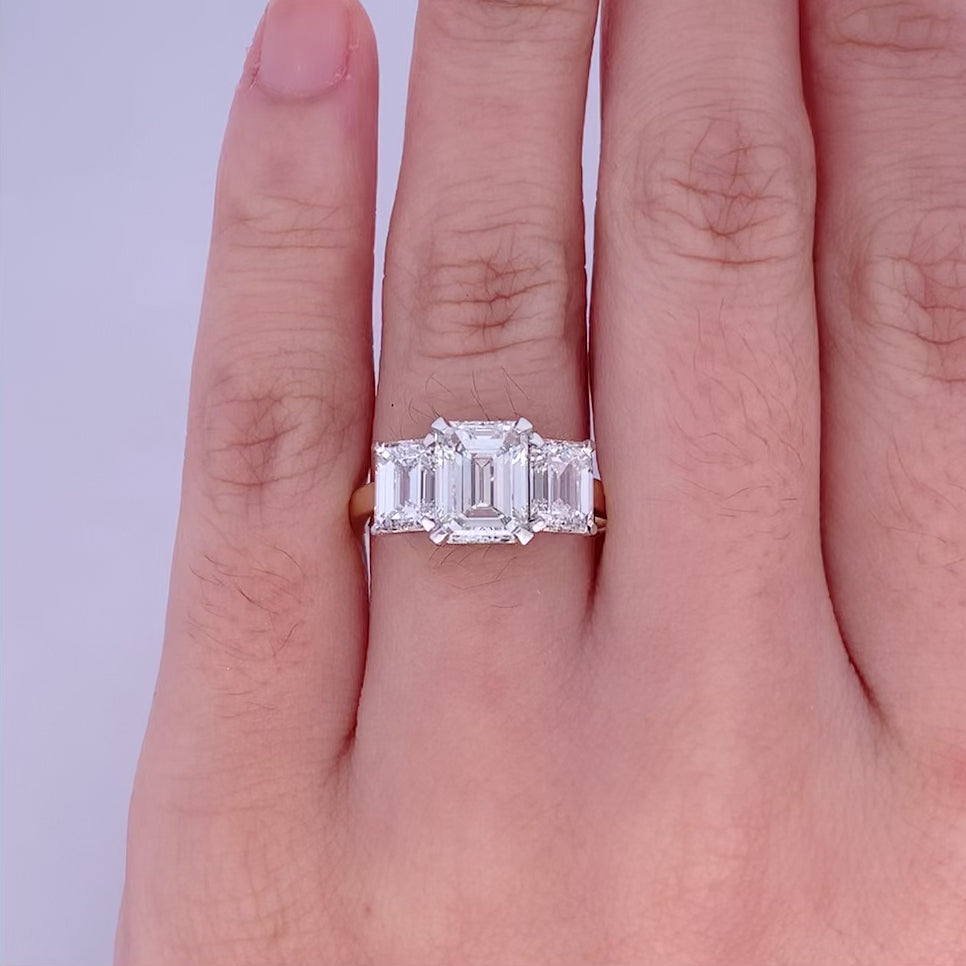 Erté: Emerald Cut Diamond Three Stone Ring